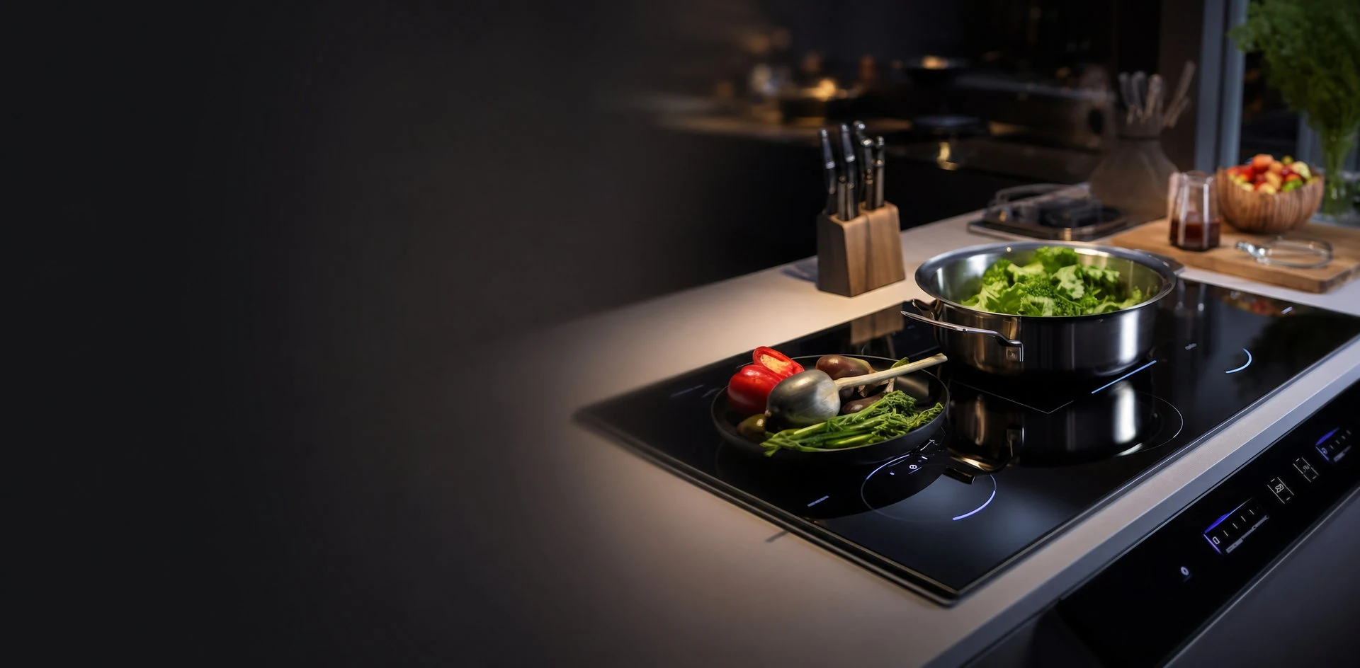 Modern kitchen with a black glass-ceramic induction cooktop in use