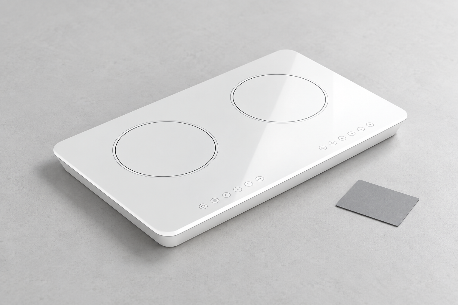 White two-zone ceramic-glass cooktop next to a neutral gray visual reference on a clean inspection table